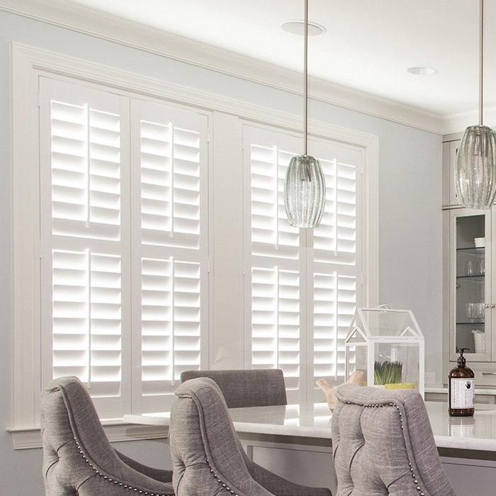 White plantation shutters in a white modern kitchen.