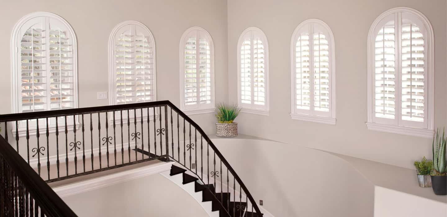 Custom treatments perfectly cover your window without sticking out and catching on the trim. Arched Plantation Shutters