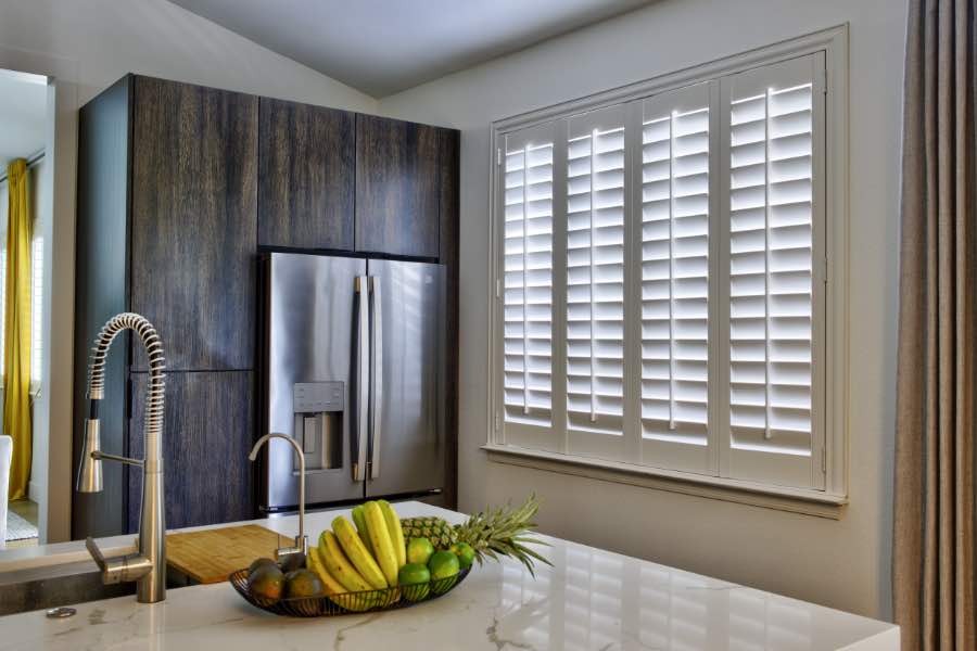 A window treatment consultant and shutter designer tool can help you pick a frame you love. Large window with interior shutters in a kitchen.
