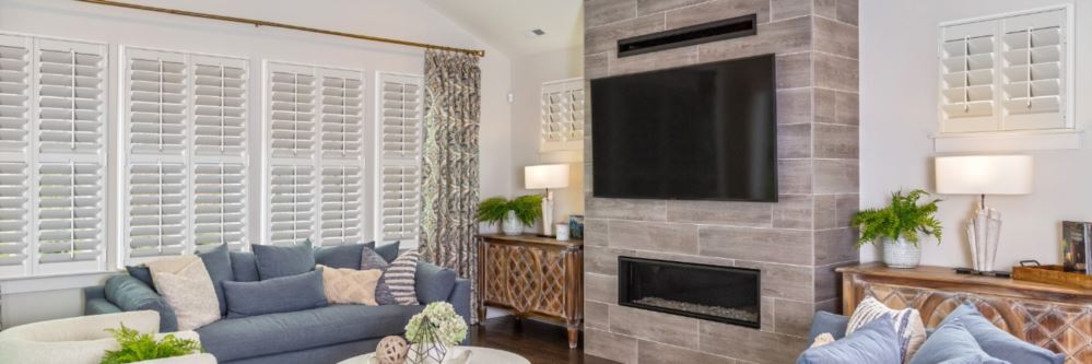 Plantation shutters in a Green Valley living room with fireplace