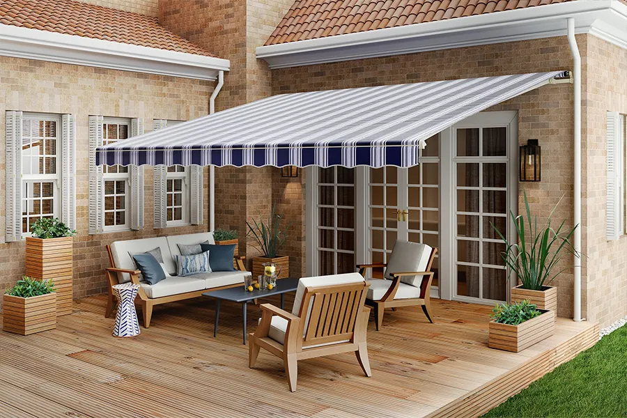 Custom awnings come in many colors and even patterns to complement your home's exterior. A white and navy blue striped awning shading a wood deck
