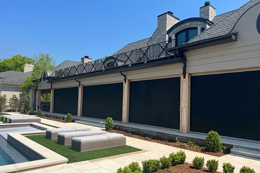 Shade screens on the front of a back porch facing a pool