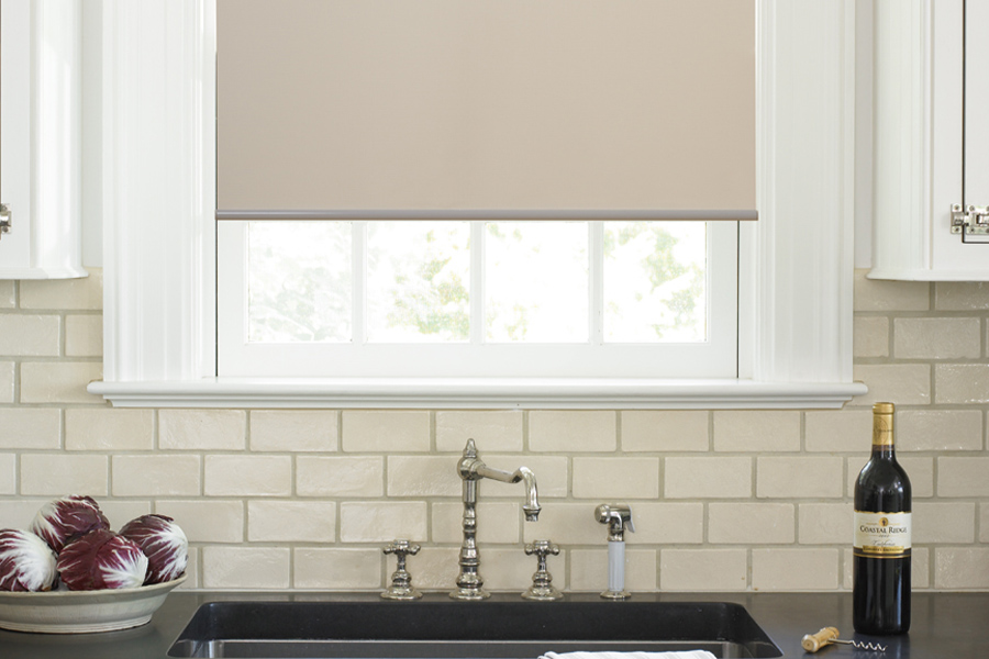 Roller shades opens up a lot of color and style options for your gourmet kitchen at Las Vegas. Roller shade above a kitchen sink.