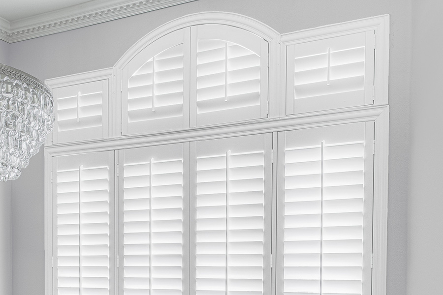 Customize your Palladian windows with white Polywood shutters in Las Vegas. White Polywood Palladian windows in a dining room.
