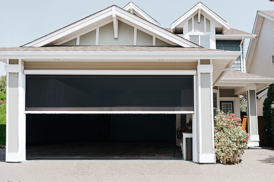 A screen shade partially lowered over a garage door